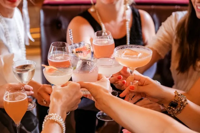 A bus full of party hens — bride hen with veil and sash, friends with party hats, sunglasses and champagne flutes — on the road to the Coal Valley vineyards